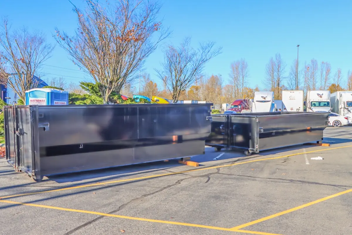 Professional dumpster rental service with roll-off container on residential driveway in Bridgeton